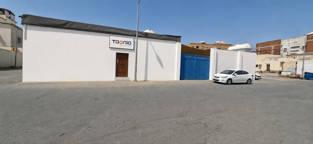 Exterior of Taqnia Technical Services facility with company signage